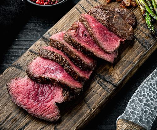 Beef steak slices on slab, cooked rare